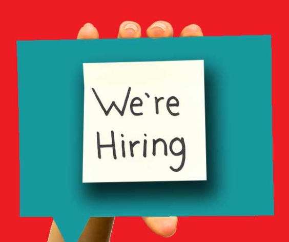 Hand holding a ``We're hiring`` card.