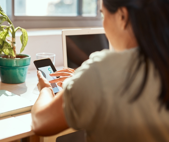 Young woman reviewing her CardNav app on her smart phone.