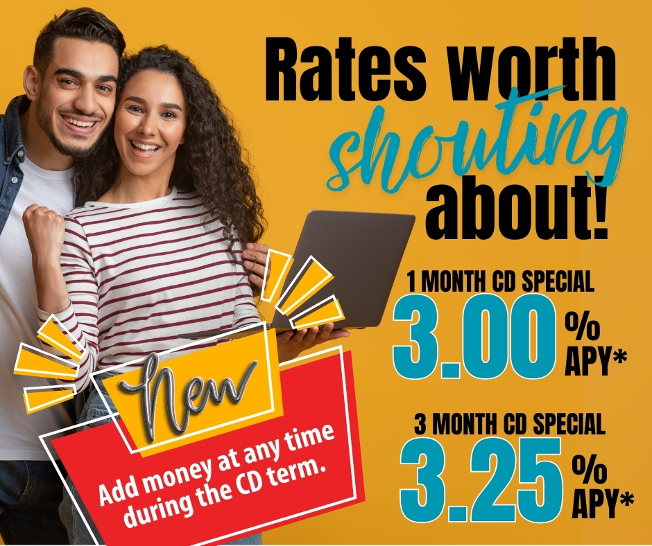 Young couple holding a laptop smiling