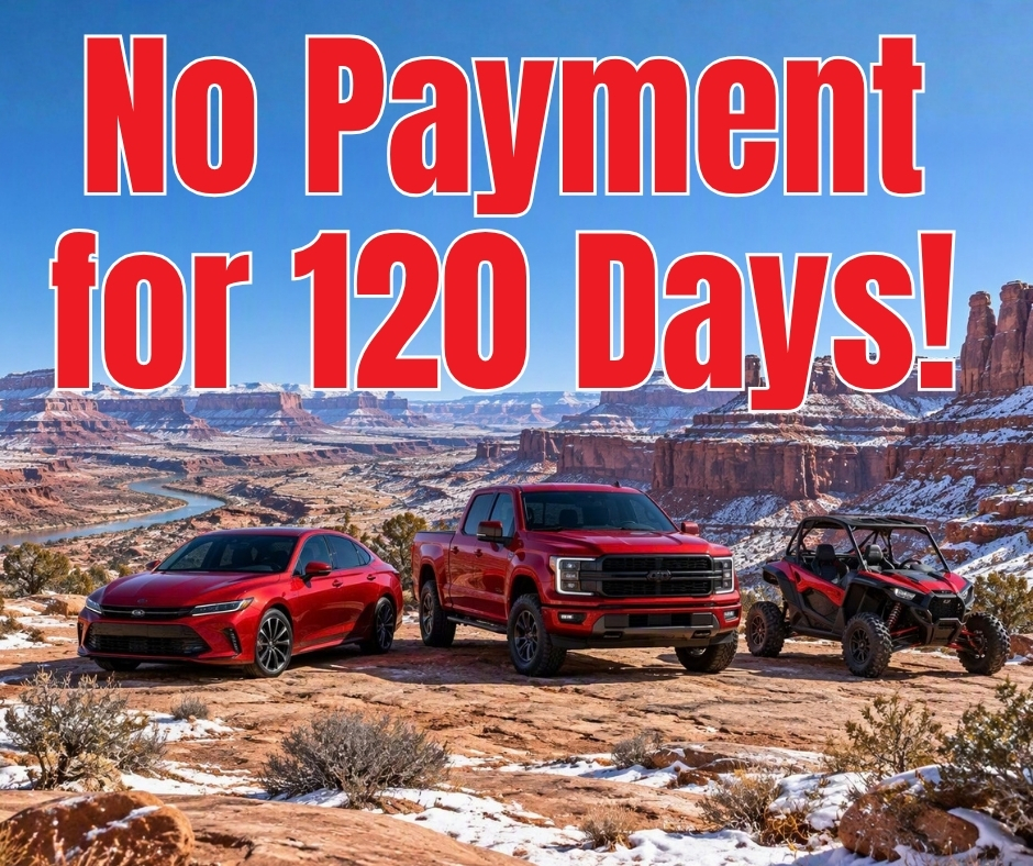 A red car and a red truck in Canyonlands.