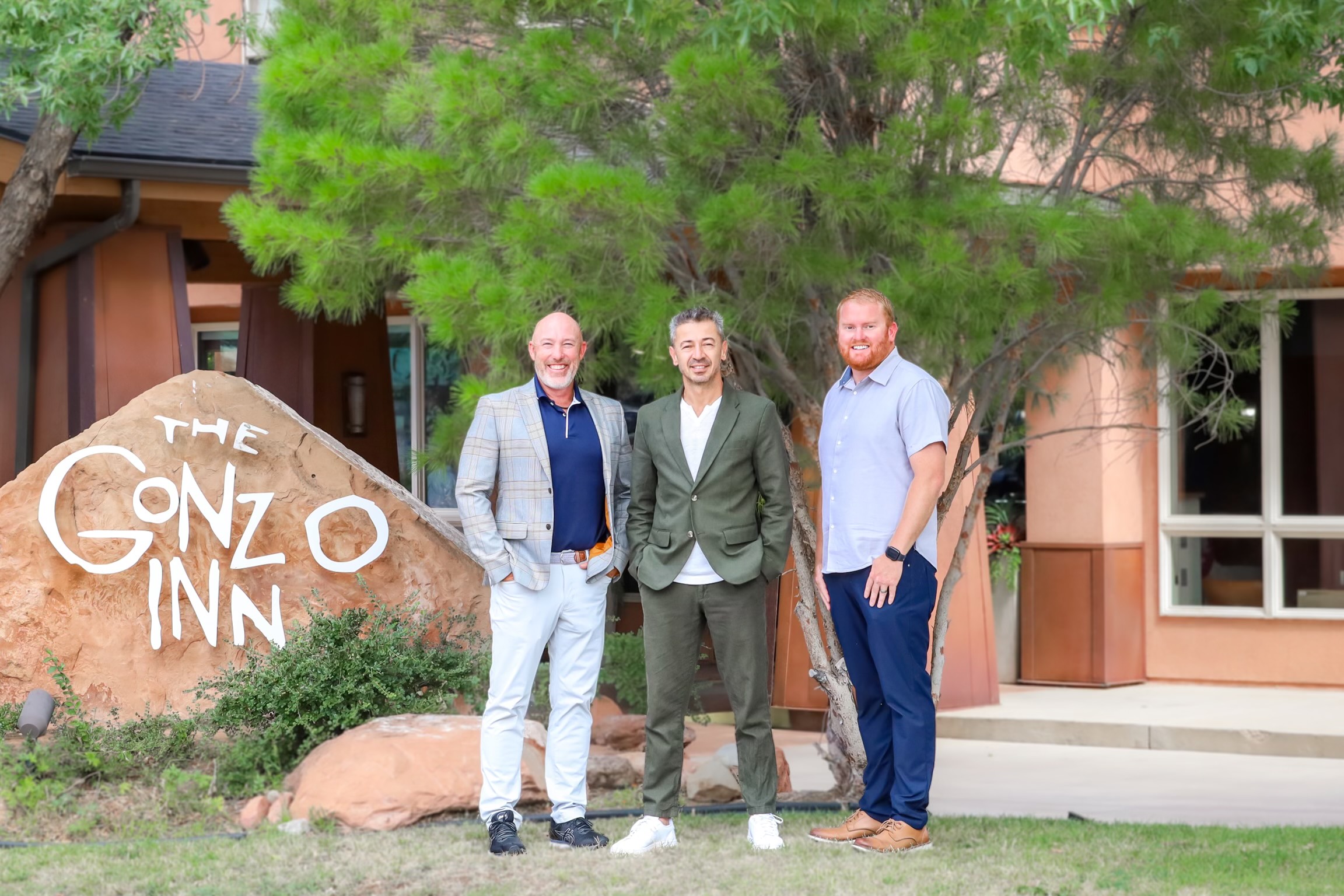 # men standing in front of Gonzo Inn
