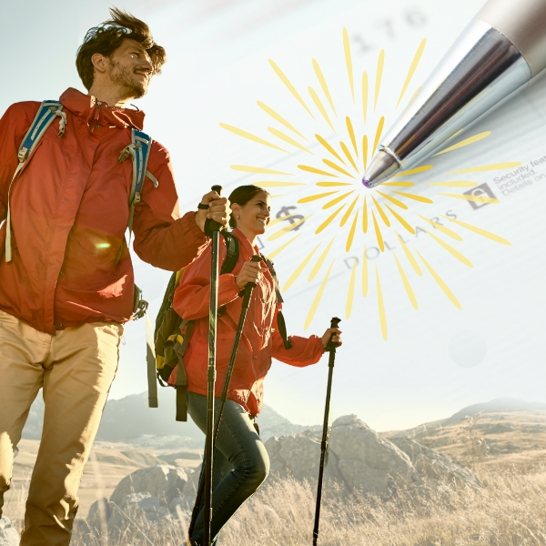 Young hiker couple reaching the summit.