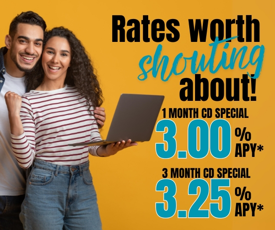 Young couple holding a laptop smiling 