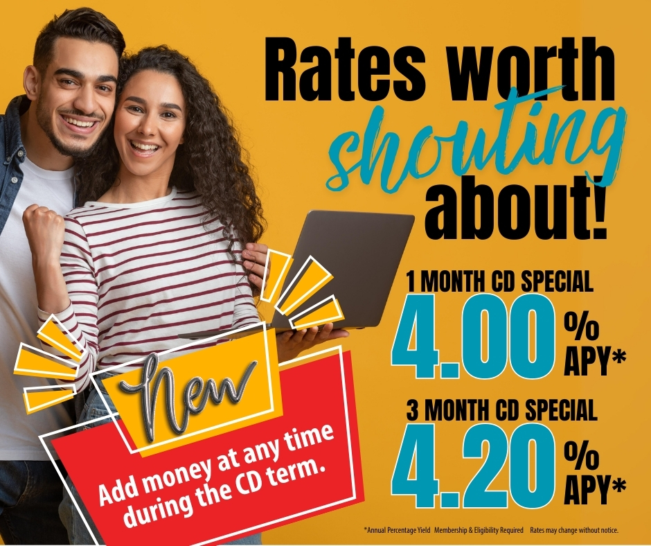 Young couple holding a laptop smiling