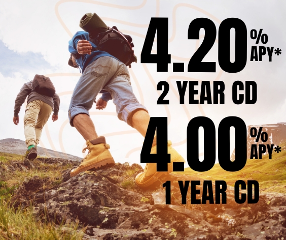 Mature couple hiking to a peak representing the high interest rates for 1 and 2 year CDs at Desert Rivers Credit Union.