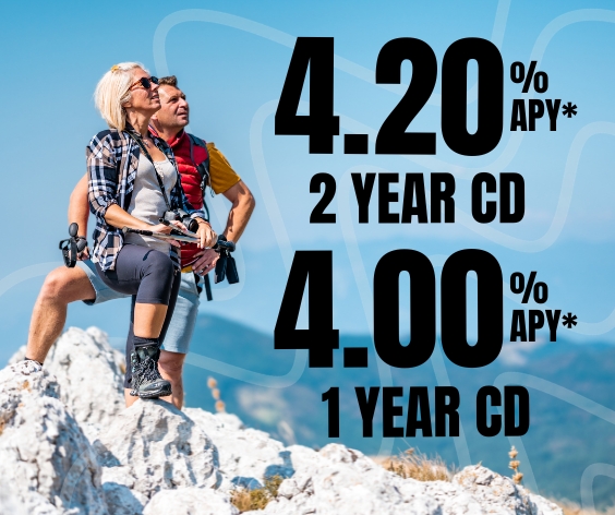 Mature couple hiking to a peak representing the high interest rates for 1 and 2 year CDs at Desert Rivers Credit Union.